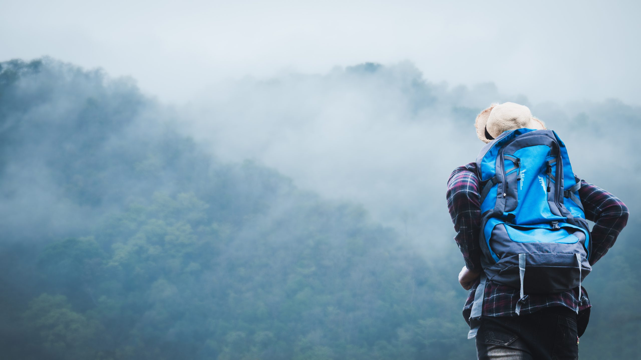 African traveler man climbing standing and looking to mountain w